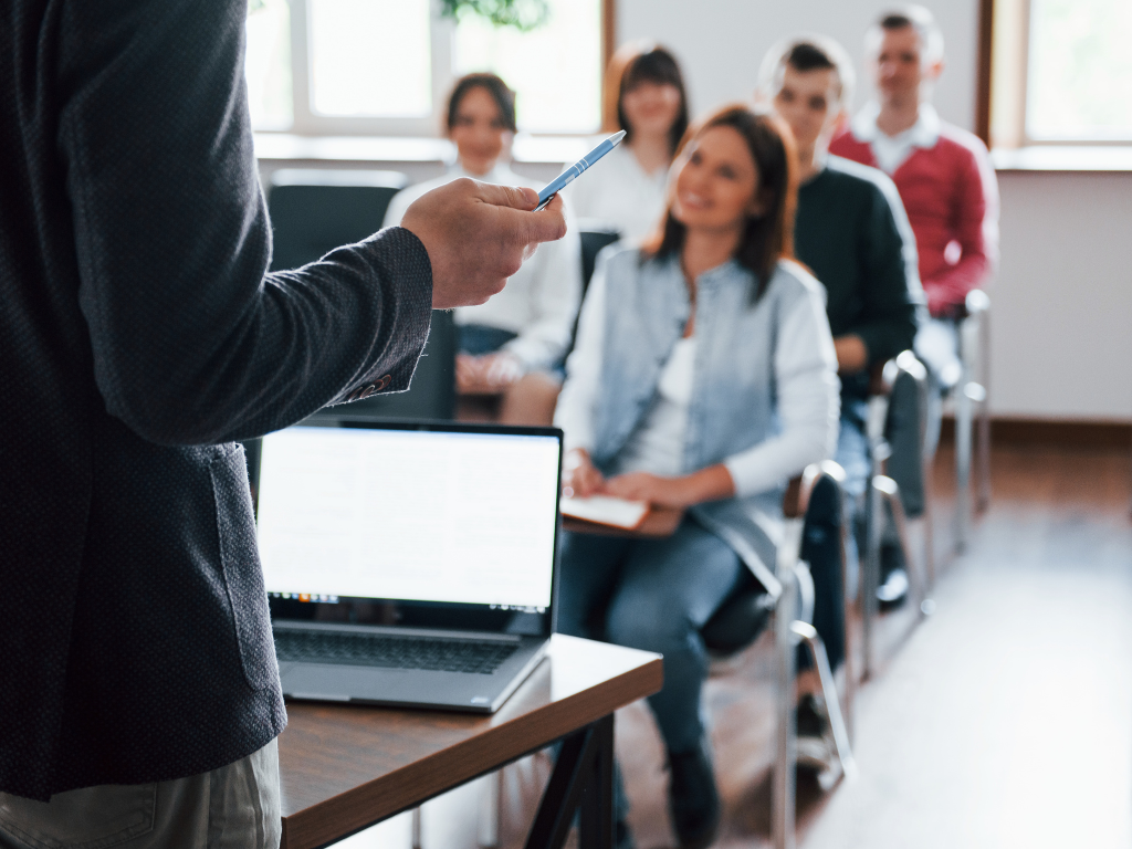 Trainer presenting to adults in a professional training session