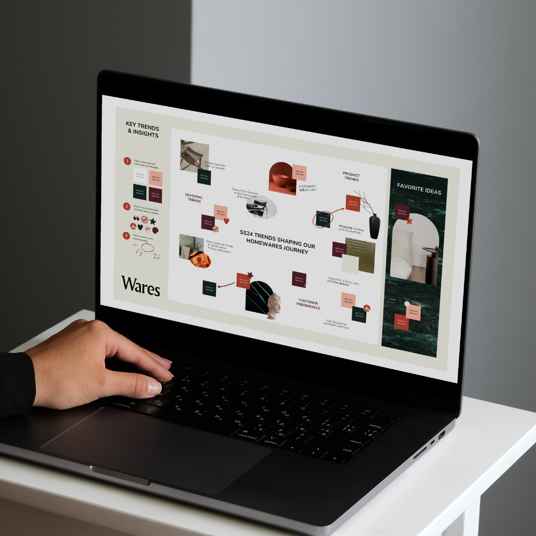 Creative professional reviewing a visual trends and content-planning board on a laptop