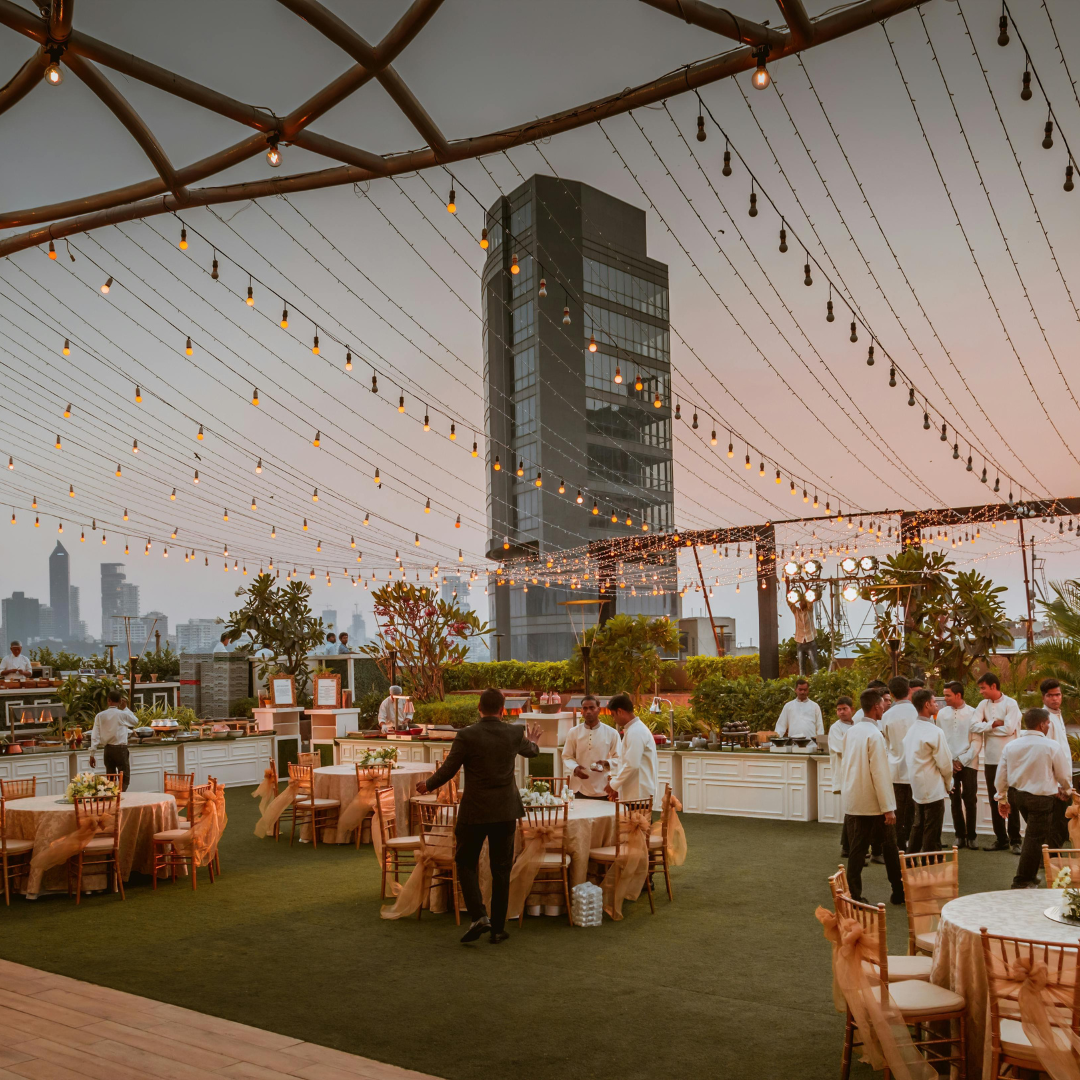 Outdoor lifestyle event venue with guests and warm string lights