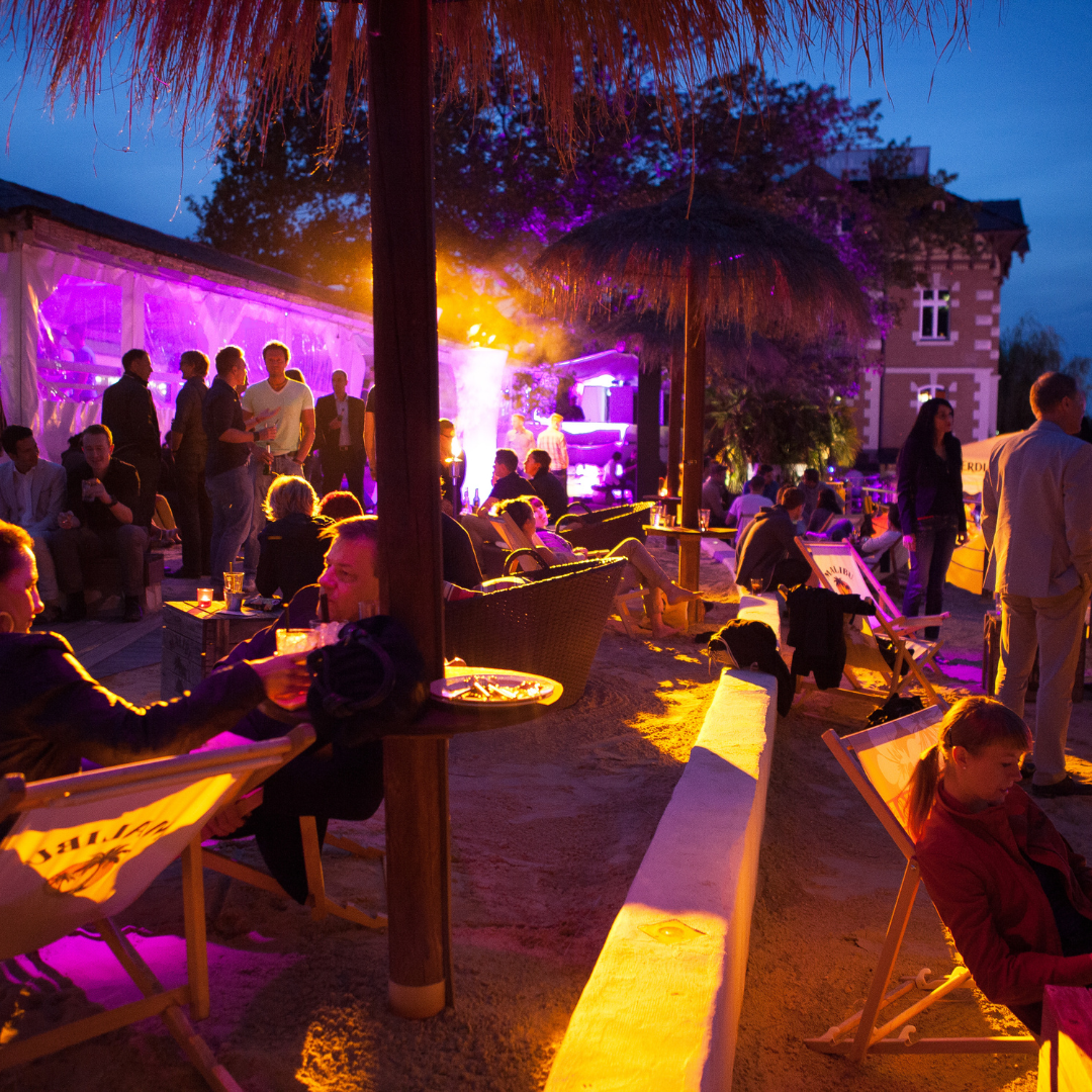 Hospitality event venue with guests and colourful evening lighting
