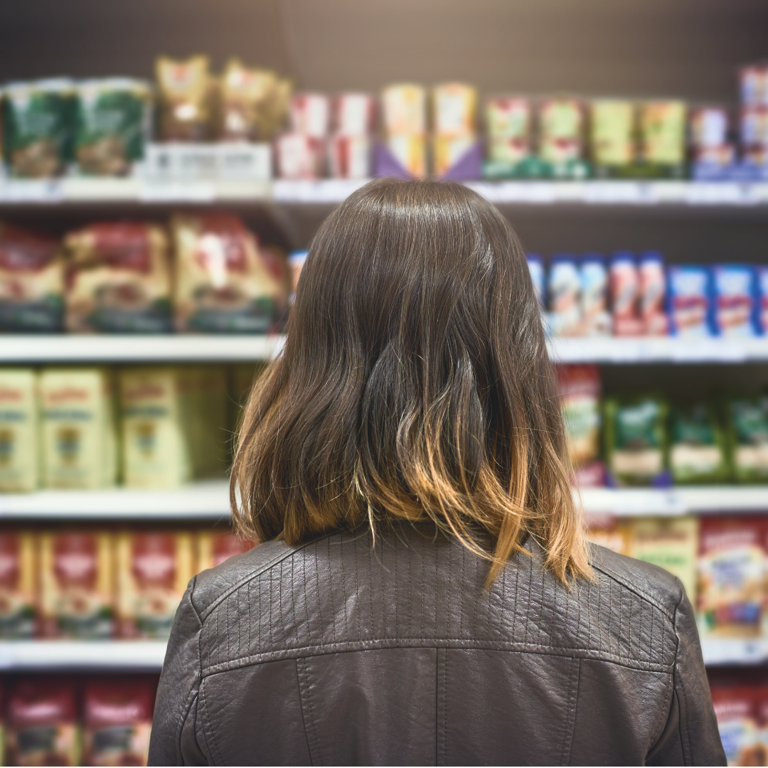 Customer browsing products on shelves for a local service brand