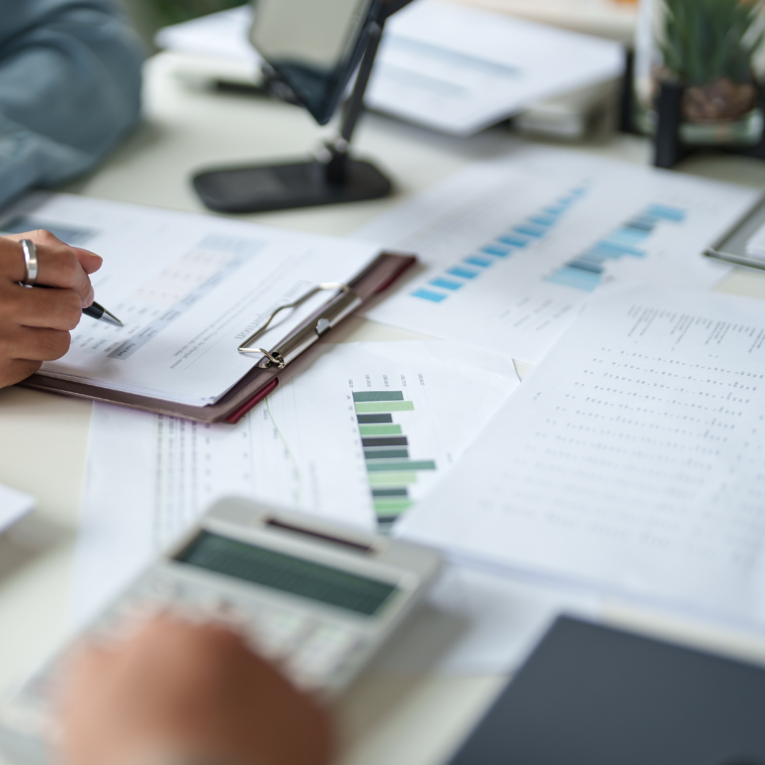 Professional service business reports and planning documents on a desk